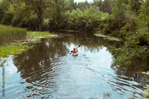 A guy and a girl canoe paddling the river © Hennadii