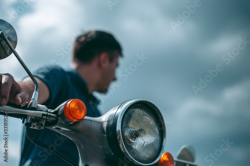 Man with motorbike looking to the side © Hennadii