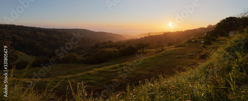Colorful sunset in Monteverde Costa Rica. The sun's rays went through the heavy rain in the valley and created this beautiful scenery.