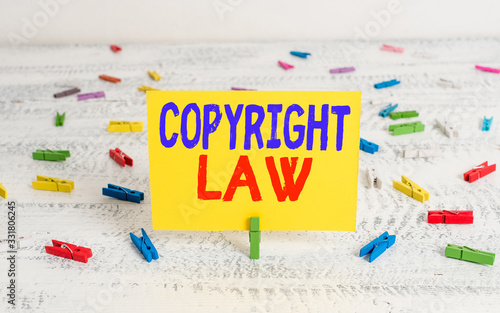 Conceptual hand writing showing Copyright Law. Concept meaning body of law that governs the original works of authorship Green clothepin white wood background reminder office supply