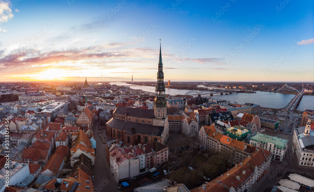 Aerial panoramic view to histirical center Riga, quay of river Daugava. Famous Landmark - st. Peter's Church's tower and City Dome Cathedral church, Old Town Monument. Latvia, Europe. shot from drone