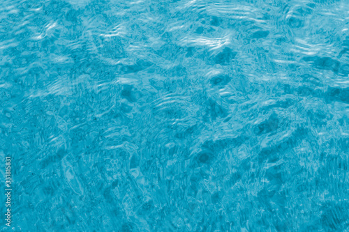 Bright blue water in the pool with ripples. Close-up shot for your inspirational design.