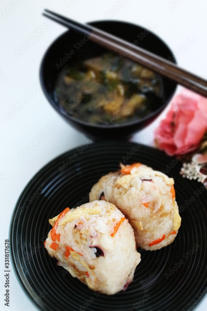 Japanese food, chicken and carrot rice ball on dish Japanese food, chicken and carrot rice ball on dish