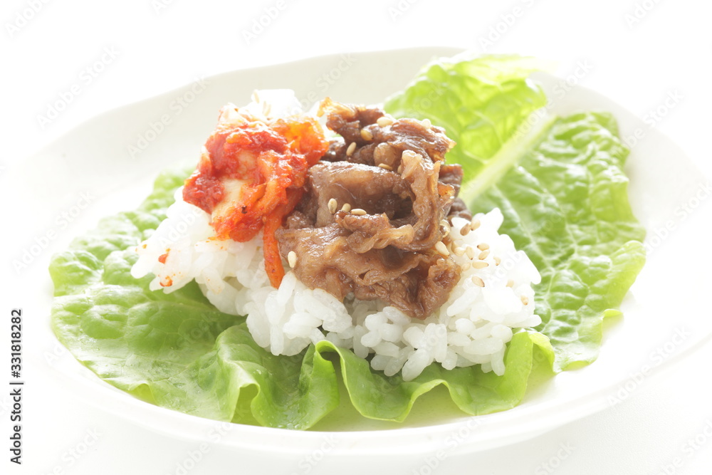 Korean food, grilled beef and kimchi on rice wrapped by lettuce Korean food, grilled beef and kimchi on rice wrapped by lettuce