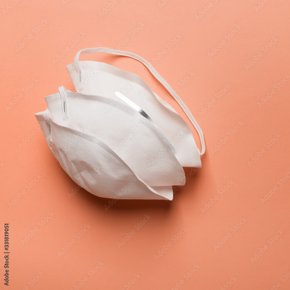 Anti coronavirus Covid-19 protective mask on orange background Anti coronavirus Covid-19 protective mask on orange background