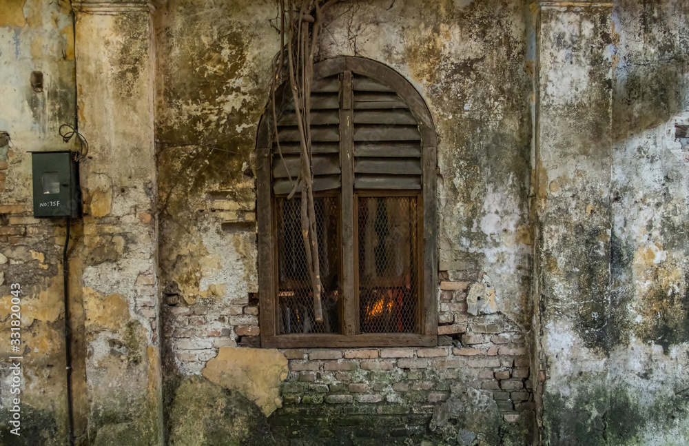 Fototapeta premium Old window on weathered buildings.