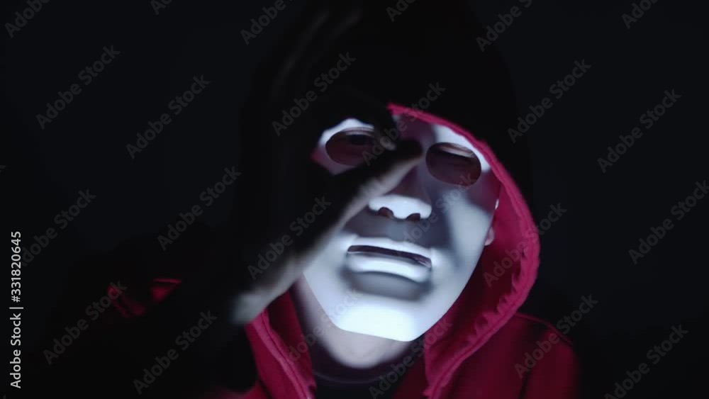 Ok hand gesture or i see you message. Hacker with mask in red hoodie in the dark room illuminated by flash light and surrounded by smoke Ok hand gesture or i see you message. Hacker with mask in red hoodie in the dark room illuminated by flash light and surrounded by smoke