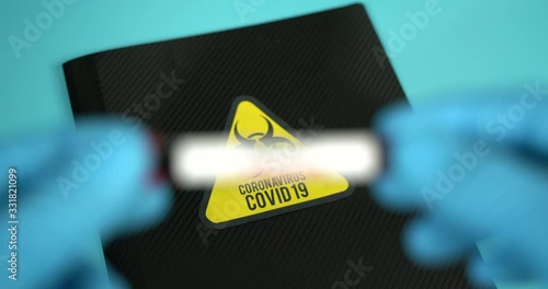 Doctor holds COVID 19 Coronavirus vaccine in his hand, infected blood sample in the sample tube, Vaccine and syringe injection It use for prevention, immunization and treatment from COVID-19