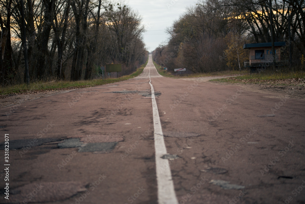 The road in the forest in Pripyat in Chernobyl