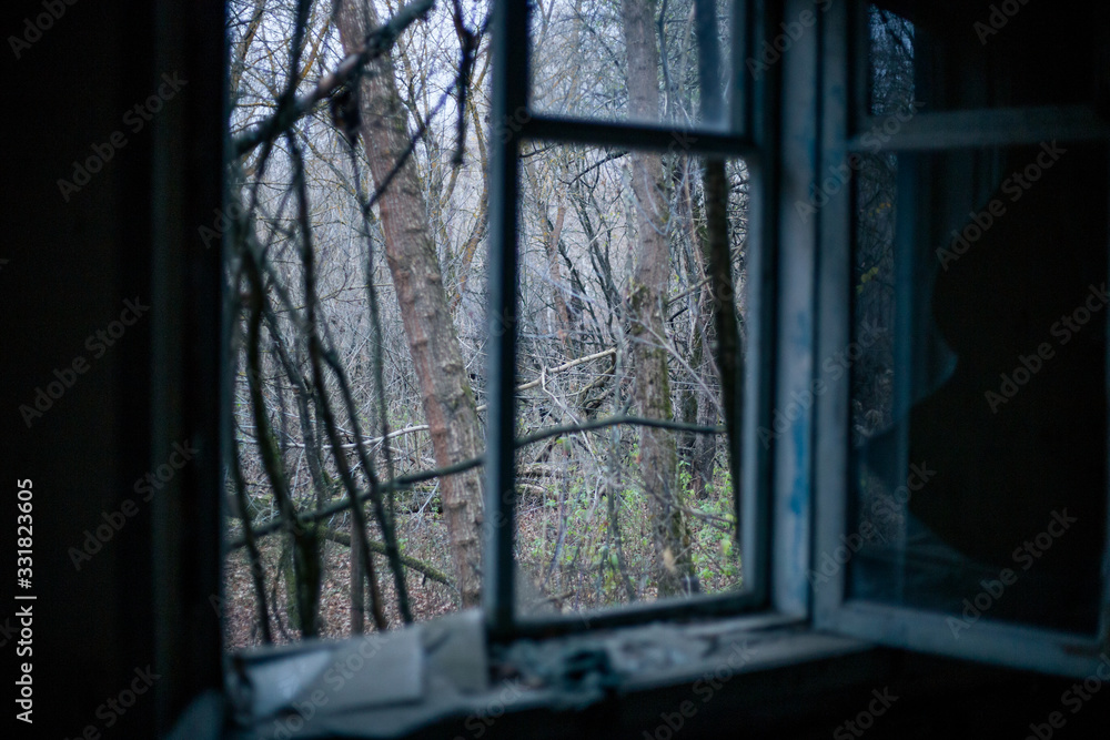 Naklejka premium Old windows in the house in Pripyat in Chernobyl