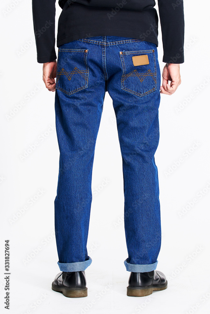Naklejka premium Male model in blue jeans bottom on white background.