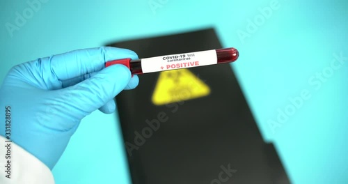 Doctor holds COVID 19 Coronavirus vaccine in his hand, infected blood sample in the sample tube, Vaccine and syringe injection It use for prevention, immunization and treatment from COVID-19