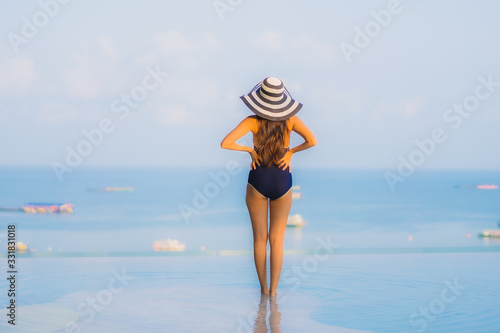 Portrait beautiful young asian woman relax around swimming pool in hotel resort