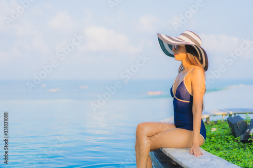 Portrait beautiful young asian woman relax around swimming pool in hotel resort