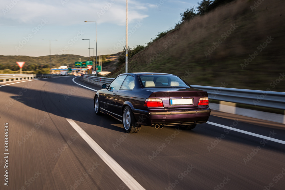 Fototapeta premium Back lights and bumper of an old model car on the road