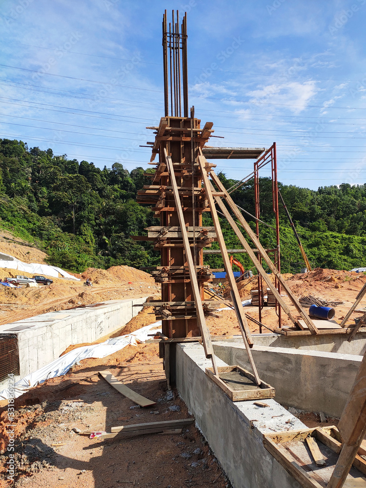Column timber form work and reinforcement bar at the construction site. Installed by construction workers. The structure supported by temporary wood support. Column timber form work and reinforcement bar at the construction site. Installed by construction workers. The structure supported by temporary wood support.