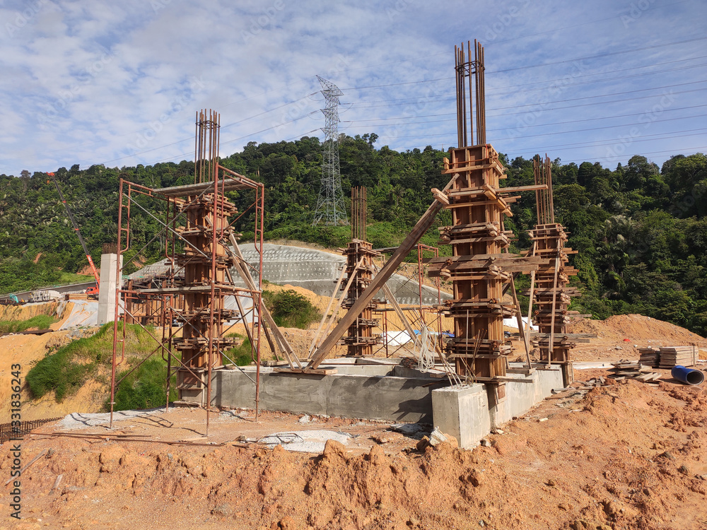 Column timber form work and reinforcement bar at the construction site. Installed by construction workers. The structure supported by temporary wood support. Column timber form work and reinforcement bar at the construction site. Installed by construction workers. The structure supported by temporary wood support.