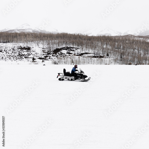 Snowmobiler driving in the backcountry
