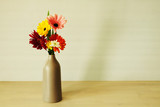 Five  color  flowers in gray vase on white background