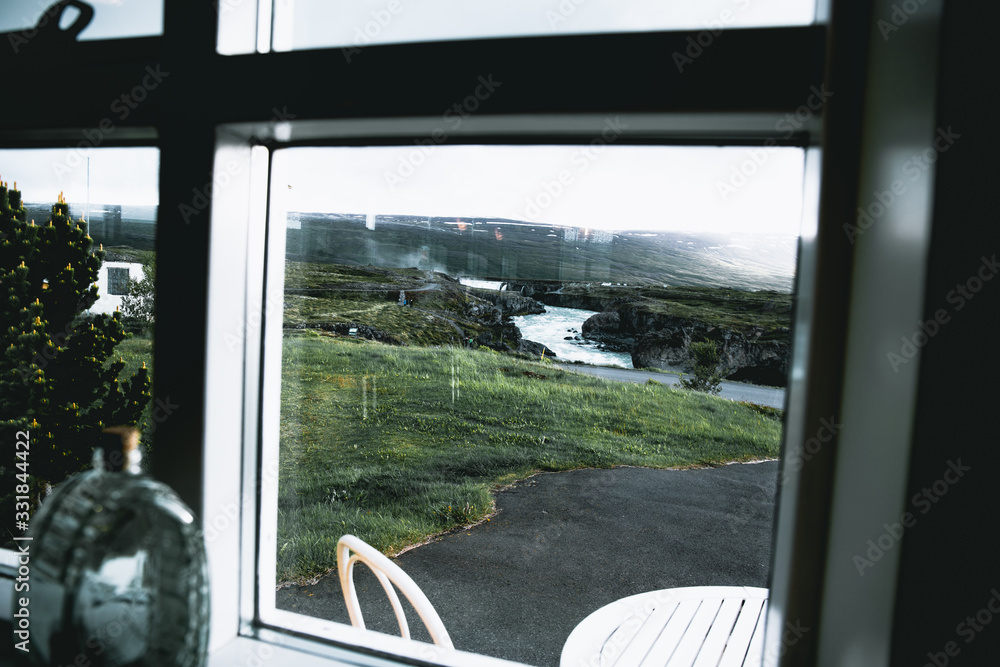 Fototapeta premium View of icelandic waterfall from a window