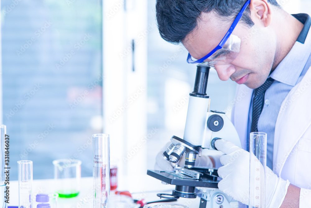 Young scientists biologists or researchers putting personal protective equipments to prevent infection from virus or bacteria disease and testing Young scientists biologists or researchers putting personal protective equipments to prevent infection from virus or bacteria disease and testing