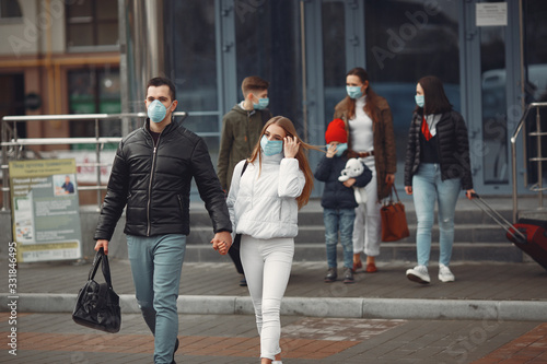 Travelers leaving airport are wearing protective masks.