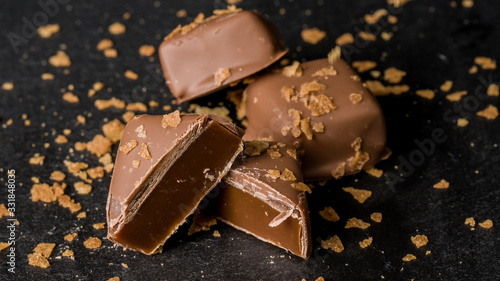 Close-up Homemade caramel Belgian chocolates on dark background