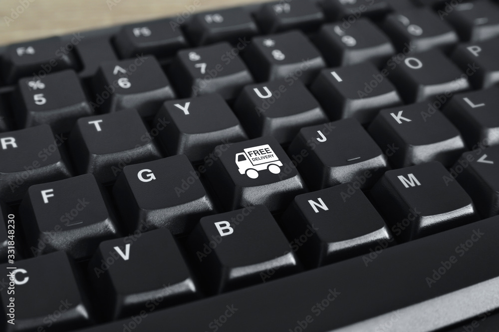 Free delivery truck flat icon on black computer keyboard button, Business transportation online concept Free delivery truck flat icon on black computer keyboard button, Business transportation online concept