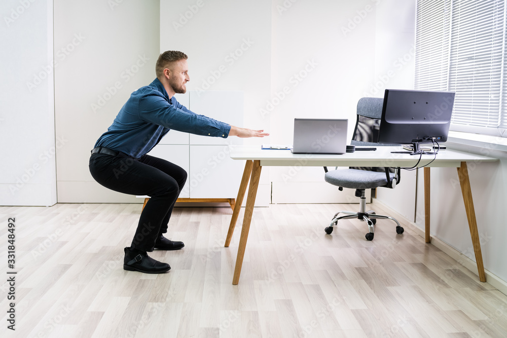 Smiling Young Businessman Doing Sit-ups Smiling Young Businessman Doing Sit-ups
