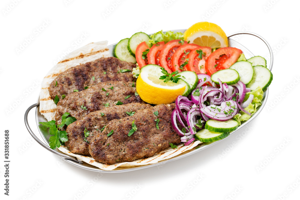 Grilled meat kebabs (cutlets) served with vegetables and tortilla, flatbread. isolated on white background Grilled meat kebabs (cutlets) served with vegetables and tortilla, flatbread. isolated on white background