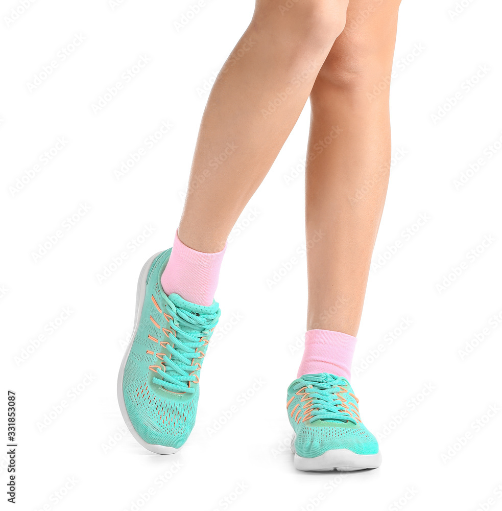 Legs of young woman in socks and shoes on white background