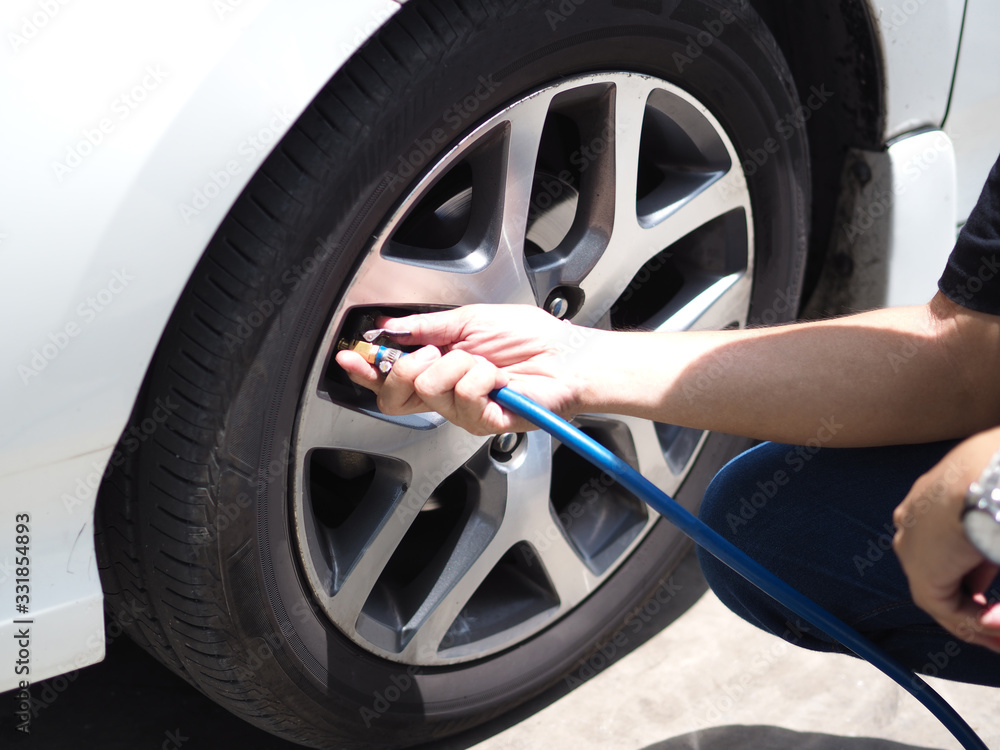 man put air into the car tire man put air into the car tire