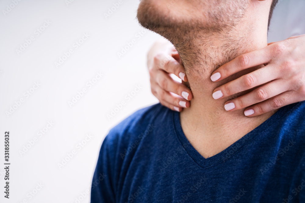 Obraz premium Doctor Checking Thyroid Of A Young Man