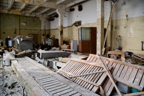 Photo of a room with the garbage of an abandoned destroyed plant. Slums, waste.