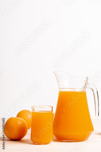 glass and jar of fresh orange juice