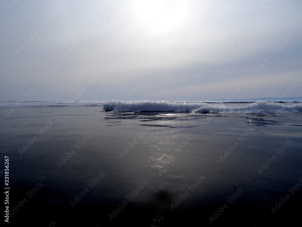 Fototapeta premium a lake covered with smooth dark ice in the evening twilight