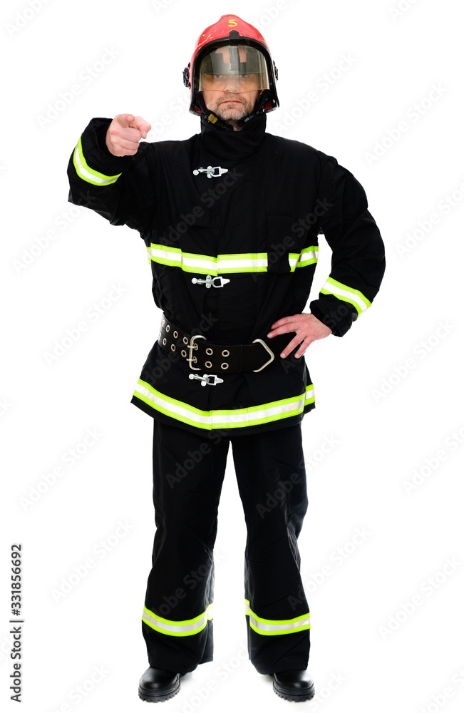 Portrait of a firefighter in black uniform in a red helmet on a white isolated background Portrait of a firefighter in black uniform in a red helmet on a white isolated background