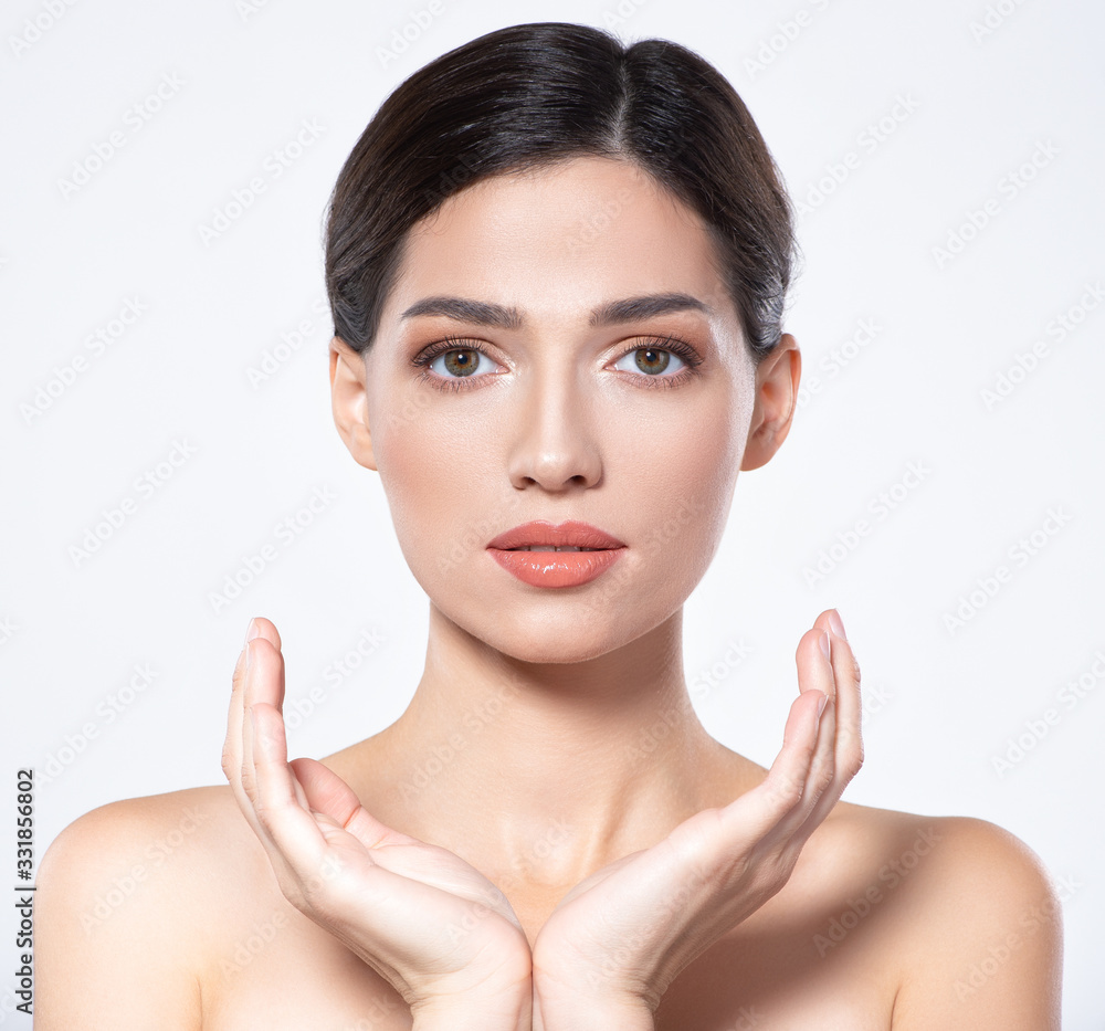 Photo of an Young girl with light natural eye makeup. Beauty face of young woman with healthy fresh skin. Portrait of beautiful brunette woman with clean skin of face - isolated on white. Photo of an Young girl with light natural eye makeup. Beauty face of young woman with healthy fresh skin. Portrait of beautiful brunette woman with clean skin of face - isolated on white.