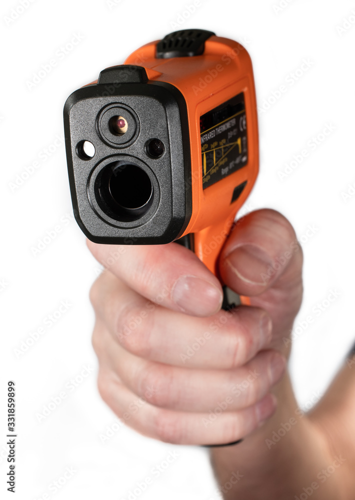 Electronic infrared pyrometer (thermometer) in a hand on a white background. Isolated. Electronic infrared pyrometer (thermometer) in a hand on a white background. Isolated.