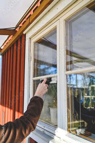 cleaning windows on a cabin with a machine photo
