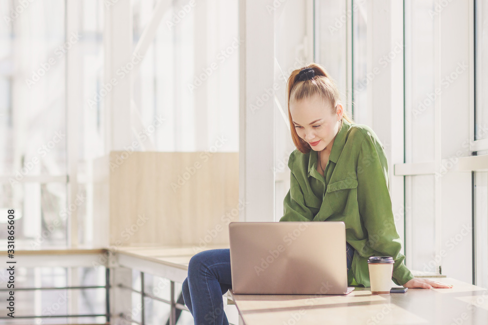 Young beautiful woman sits with a laptop Young beautiful woman sits with a laptop