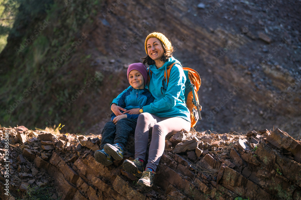 A woman is traveling with a child to the mountains.