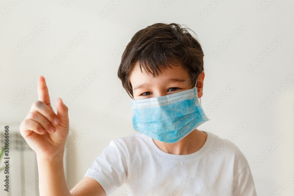 Cute little asian boy wearing health mask, looking up, isolated over white background Cute little asian boy wearing health mask, looking up, isolated over white background
