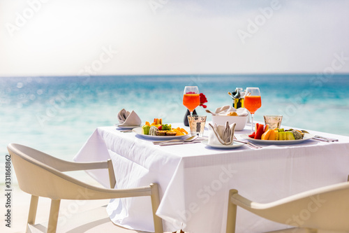 Fototapeta Naklejka Na Ścianę i Meble -  Luxury breakfast food on white table, with beautiful tropical sea view background, morning time summer holiday and romantic vacation concept, luxury travel and lifestyle