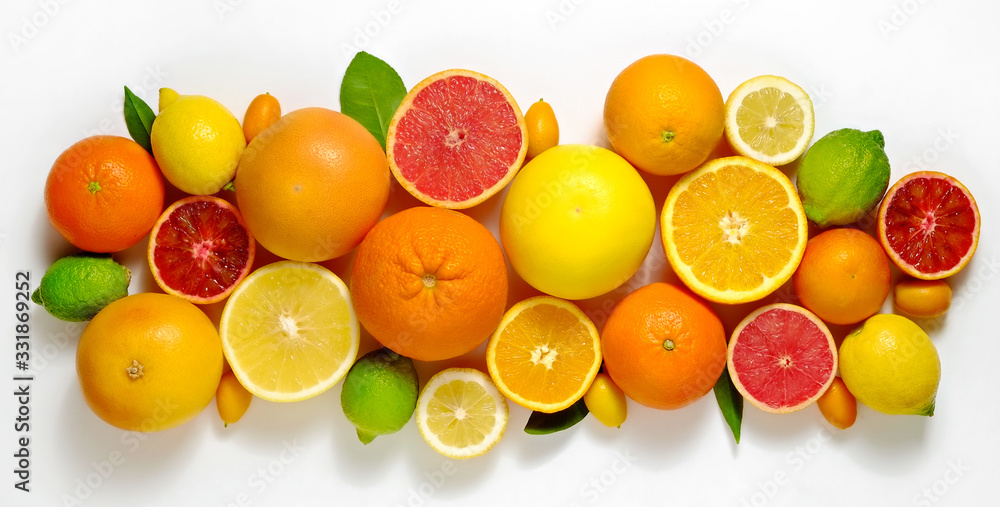 Close up image of juicy organic whole and halved assorted citrus fruits, green leaves & visible core texture, isolated white background, copy space. Vitamin C loaded food concept. Top view, flat lay.