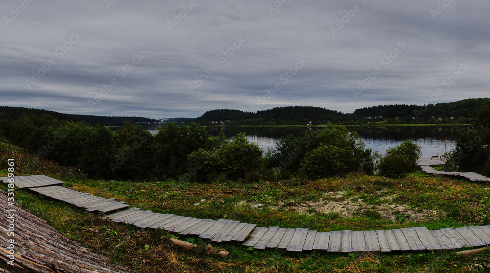 Panorama of the water landscape of Karelian nature.Panoramic view of the water surface: coniferous forest, smooth surface of the lake, open horizon. Russia, Karelia, Sortavala