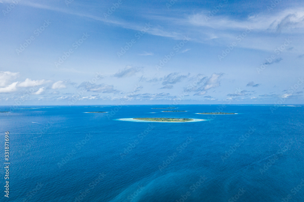 Sea plane flying above Maldives islands. Amazing tropical nature view, seascape with islands