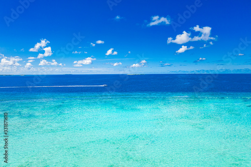 Fototapeta Naklejka Na Ścianę i Meble -  Amazing sea view and shades of blue and turquoise water at sunny day. Seascape with motorboat in bay. Summer ocean water