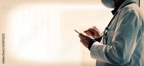 doctor with mask using mobile phone