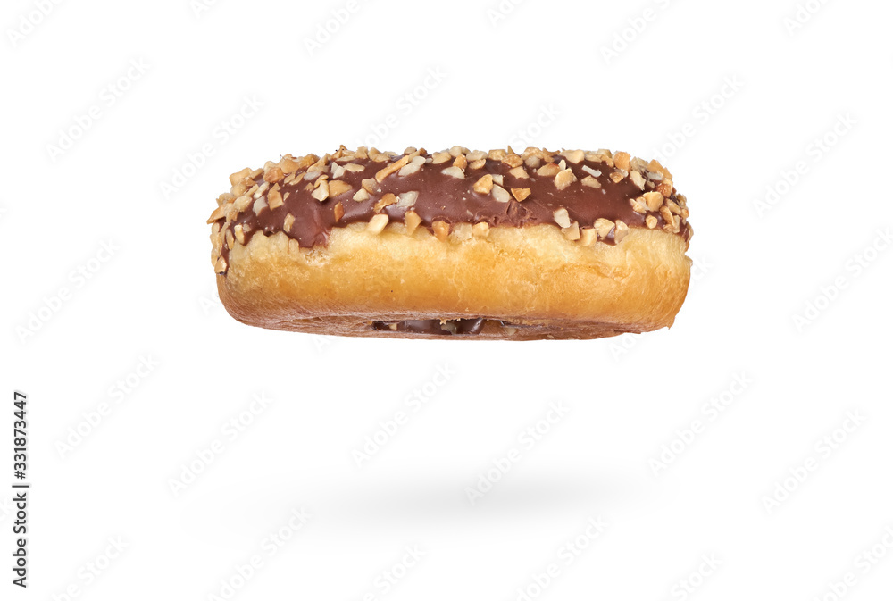 A single chocolate glazed donut with nuts isolated A single chocolate glazed donut with nuts isolated